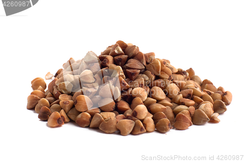 Image of heap of buckwheat on white background, closeup