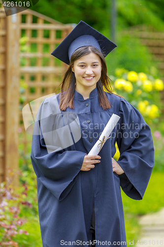 Image of Graduated young woman smiling at camera