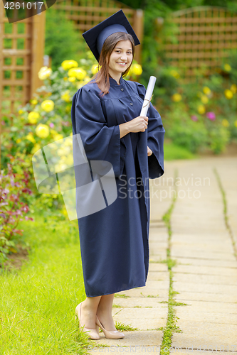 Image of Graduated young woman smiling at camera