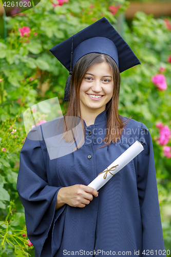 Image of Graduated young woman smiling at camera