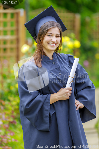 Image of Graduated young woman smiling at camera