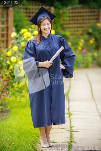 Image of Graduated young woman smiling at camera