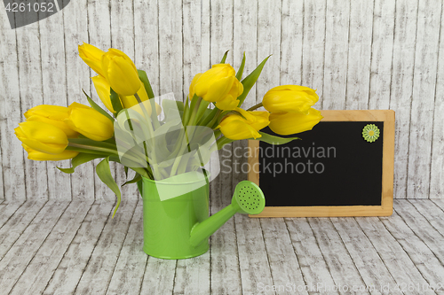 Image of Beautiful flowers and blank blackboard