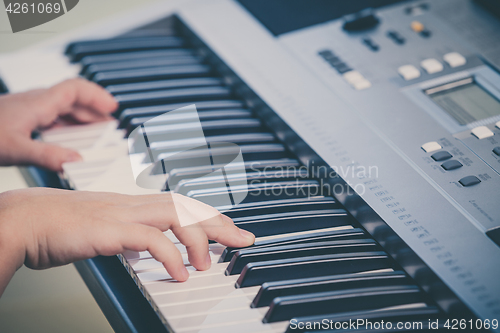 Image of Little girl playing synthesizer