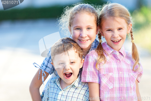 Image of Portrait of happy children near a house 