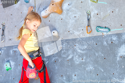Image of little girl climbing a rock wall