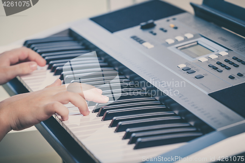 Image of Little girl playing synthesizer