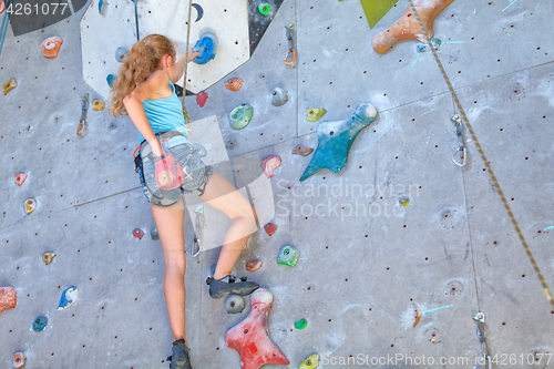 Image of teenager climbing a rock wall