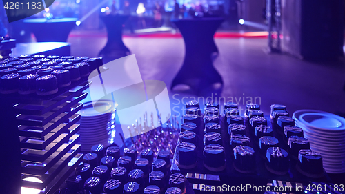 Image of stylish luxury decorated orange candy bar for the celebration of a wedding of happy couple, cathering in the restaurant.