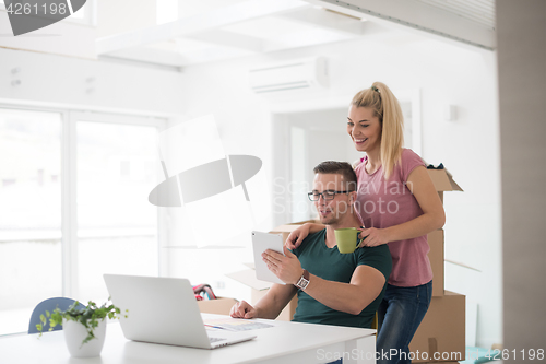 Image of Young couple moving in a new home