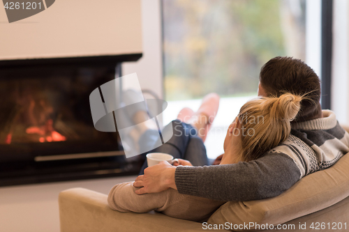 Image of Young couple  in front of fireplace