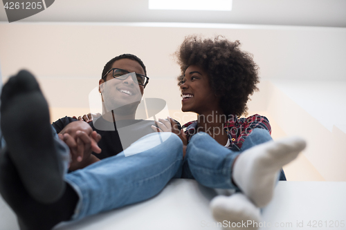 Image of couple having break during moving to new house