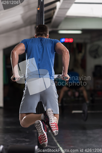 Image of man doing exercises parallel bars