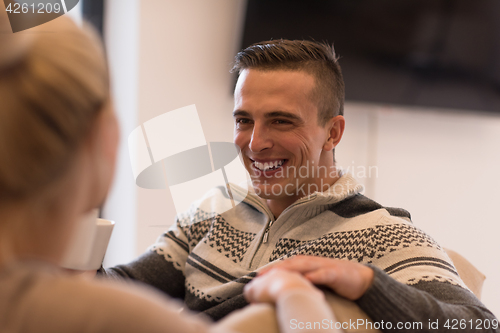 Image of Young couple  in front of fireplace