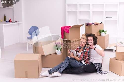 Image of young couple moving  in new house