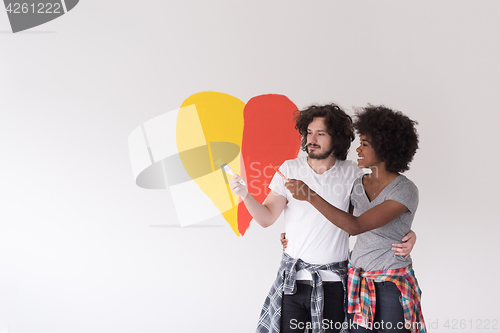 Image of couple with painted heart on wall