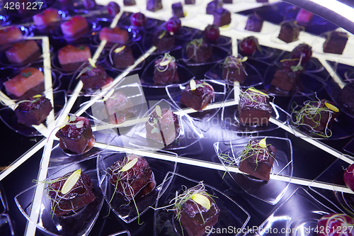 Image of Beautifully decorated catering banquet table with different food snacks.