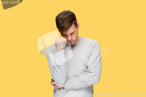 Image of Tired businessman or The serious young man over yellow studio background with headache emotions