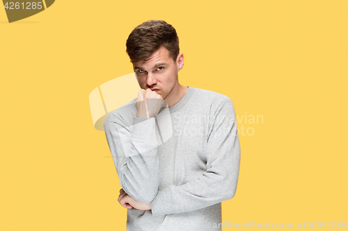 Image of Tired businessman or The serious young man over yellow studio background with headache emotions