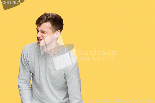 Image of Tired businessman or The serious young man over yellow studio background with pain