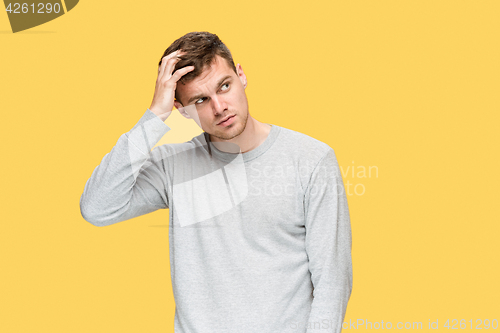 Image of Tired businessman or The serious young man over yellow studio background with headache emotions