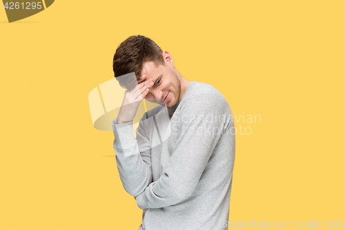 Image of Tired businessman or The serious young man over yellow studio background with headache emotions