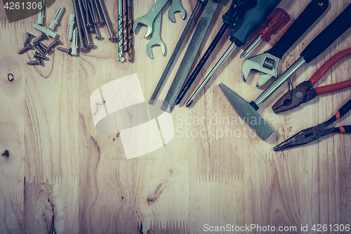 Image of Set of different tools on wooden background