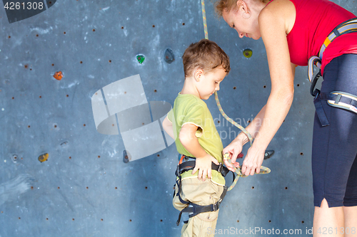 Image of little boy climbing a rock wall