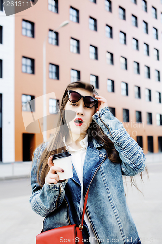 Image of young pretty hipster girl student with coffee cup posing adorable smiling, lifestyle people concept outdoor