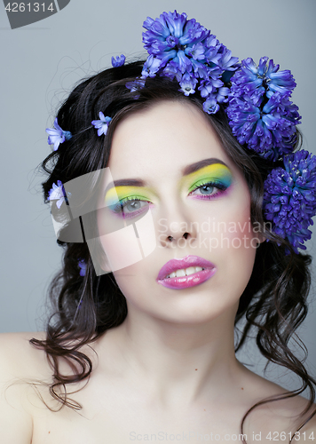 Image of Beauty young woman with flowers and make up close up, real spring beauty girl floral