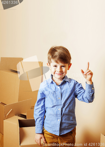 Image of little cute boy in empty room, remoove to new house. home alone,