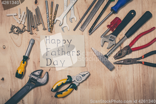 Image of Set of different tools on wooden background