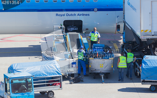 Image of AMSTERDAM, NETHERLANDS - AUGUST 17, 2016: Loading luggage in air