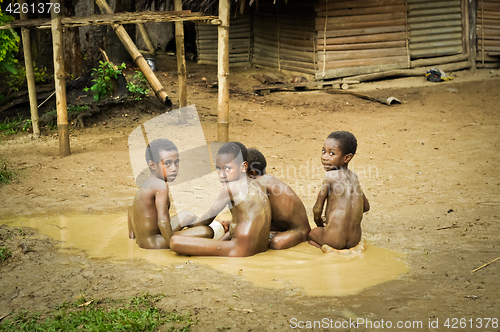 Image of Four boys in mud