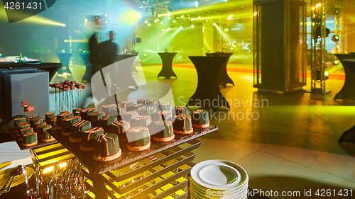 Image of stylish luxury decorated orange candy bar for the celebration of a wedding of happy couple, cathering in the restaurant.