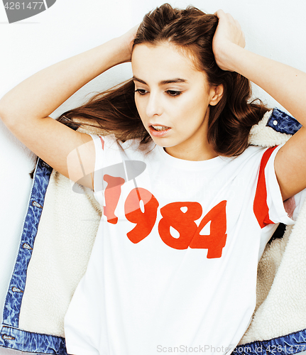 Image of young pretty teenage hipster girl posing emotional happy smiling on white background, lifestyle people concept 