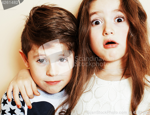 Image of little cute boy and girl hugging playing on white background, ha