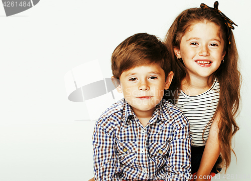 Image of little cute boy and girl hugging playing on white background, ha