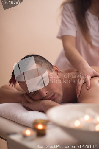 Image of young man having a back massage