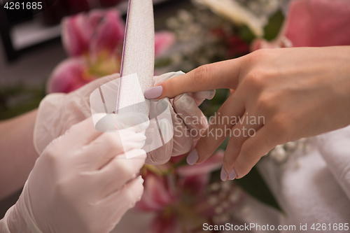 Image of Woman hands receiving a manicure