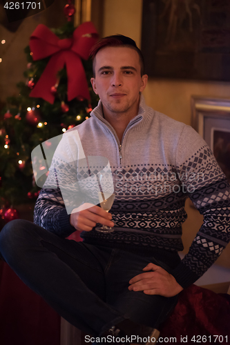 Image of Happy young man with a glass of champagne