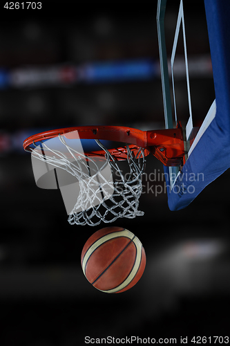 Image of basketball ball and net on black background