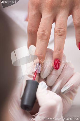 Image of Woman hands receiving a manicure