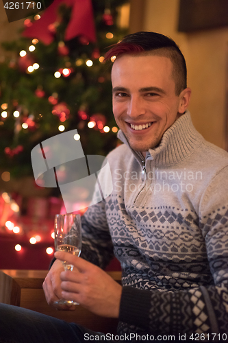 Image of Happy young man with a glass of champagne