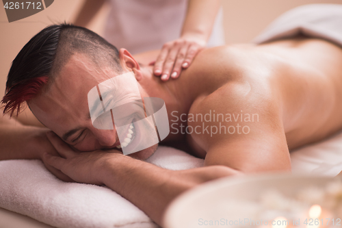 Image of young man having a back massage