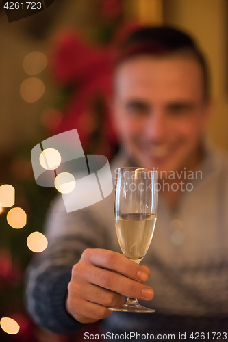 Image of Happy young man with a glass of champagne