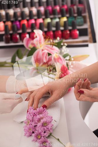 Image of Woman hands receiving a manicure