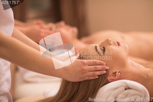 Image of couple enjoying head massage at the spa