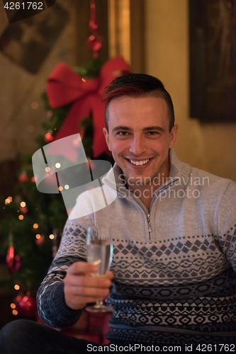 Image of Happy young man with a glass of champagne