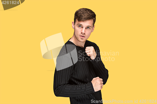 Image of The young man with a raised fist